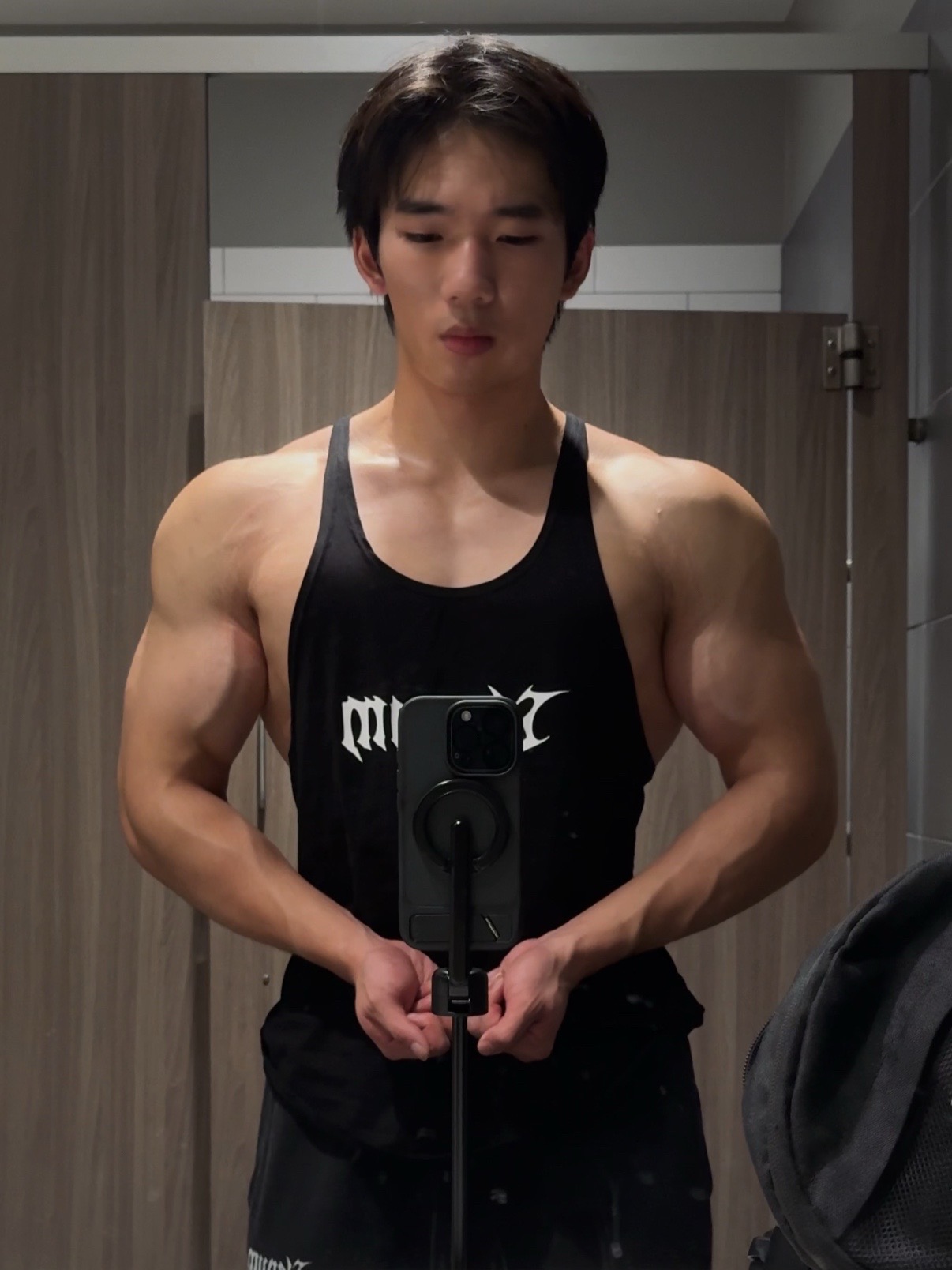 Khoi taking a progress photo at the gym